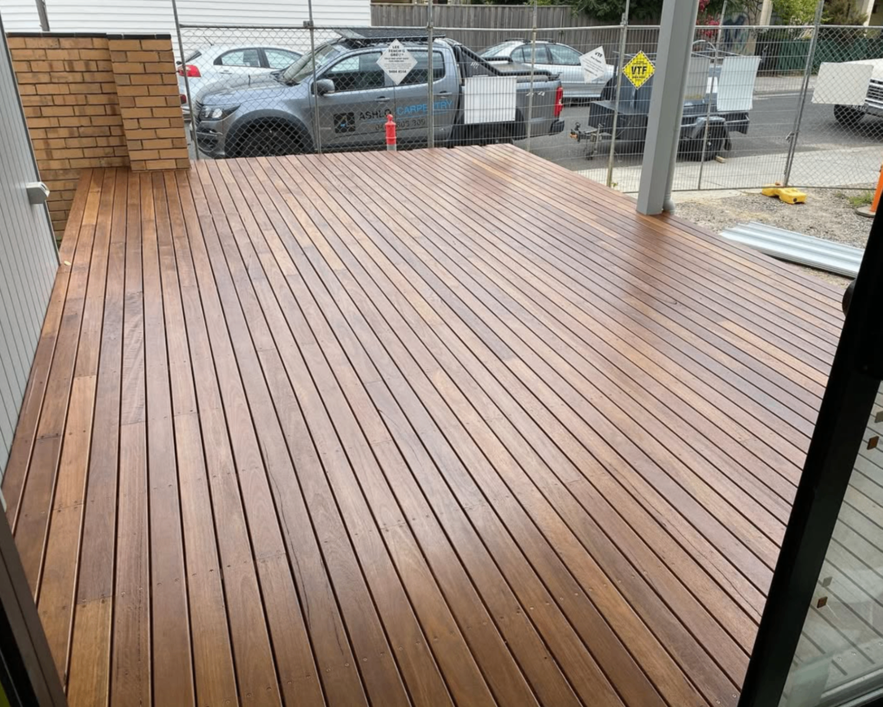 Spotted gum hardwood deck completed at a Melbourne build site, with Ashlo Carpentry ute on site